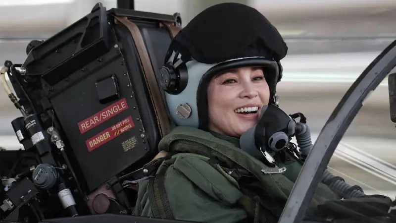 Drottningen i flyghjalm och syrgasmask i en cockpit